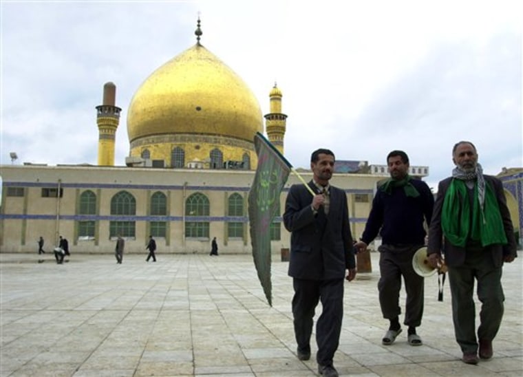 Pilgrims walk in front of the famous al-Askari mosque in Samarra, Iraq, on Feb. 2, 2004. A car bomb killed eight pilgrims Thursday, Feb. 10, on the road to one of Iraq's holiest Shiite shrines, a highly sensitive site still being rebuilt after a 2006 attack that sheered off its gleaming golden dome and engulfed the country in years of sectarian bloodshed.
